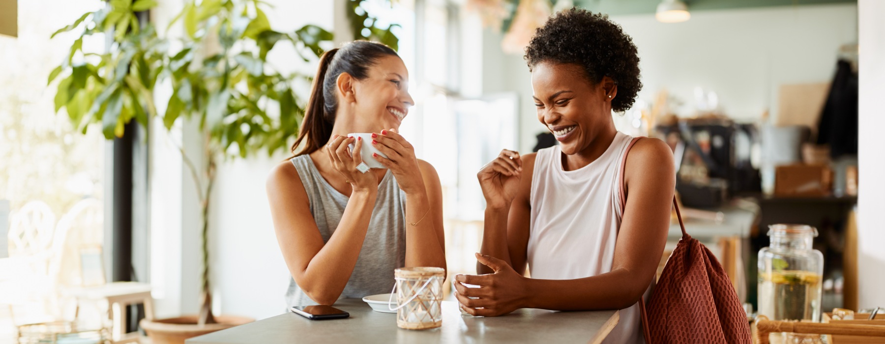 two women at a restaurant laughing 