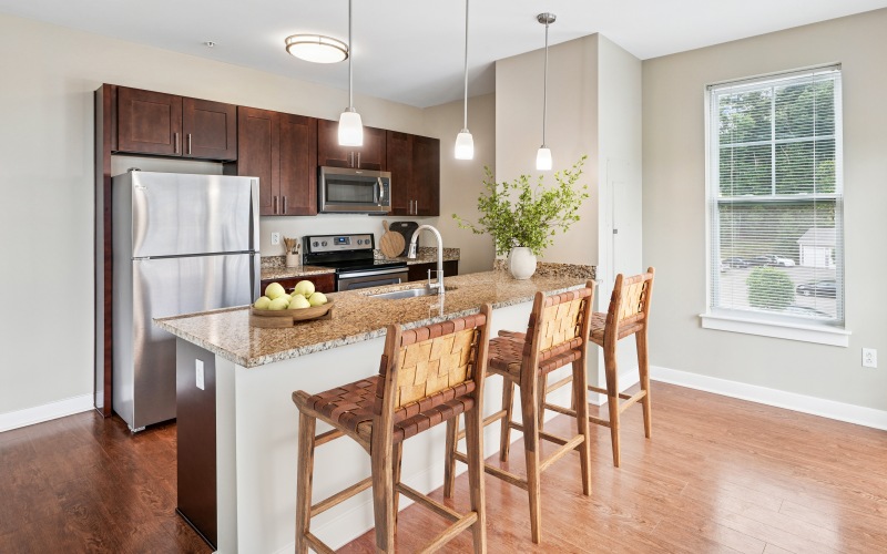 a kitchen with an island and chairs