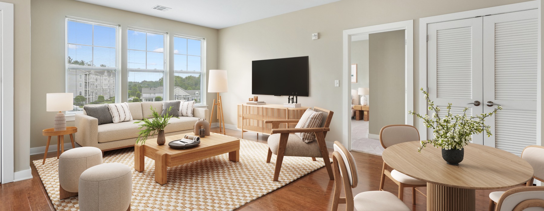 Furnished living room with view of bedroom and dining table with chairs