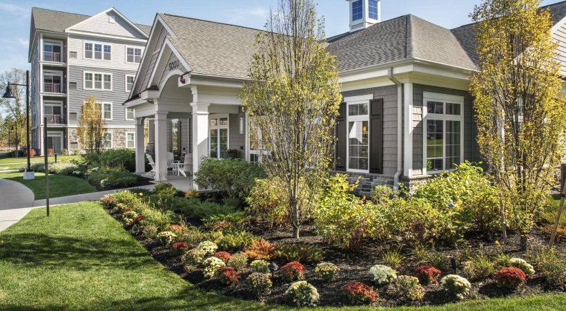 a large house with a garden in front of it