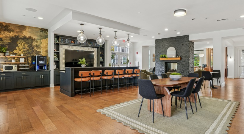 clubhouse with a large dining table and fireplace with seating